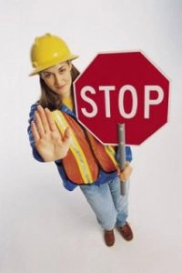 woman with a roadblock stop sign