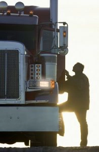 man climbing into truck